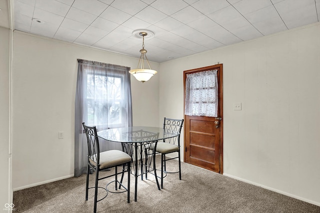 dining area featuring plenty of natural light, carpet floors, and baseboards
