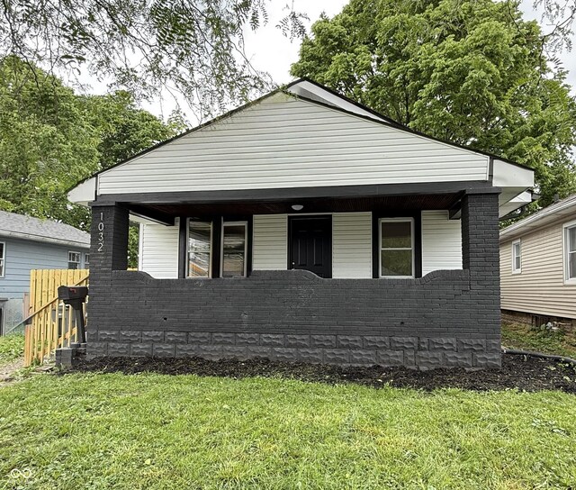 1032 Groff Ave, Indianapolis, IN 46222 - view of front of house featuring a front yard, covered porch, and brick siding