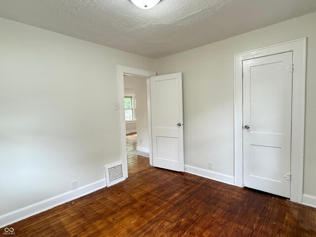 1032 Groff Ave, Indianapolis, IN 46222 - unfurnished bedroom featuring wood finished floors, baseboards, and a textured ceiling