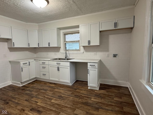 1032 Groff Ave, Indianapolis, IN 46222 - kitchen with a sink, dark wood-type flooring, a textured ceiling, light countertops, and white cabinetry