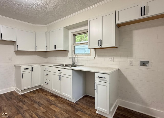 1032 Groff Ave, Indianapolis, IN 46222 - kitchen featuring a sink, dark wood-style flooring, a textured ceiling, light countertops, and ornamental molding