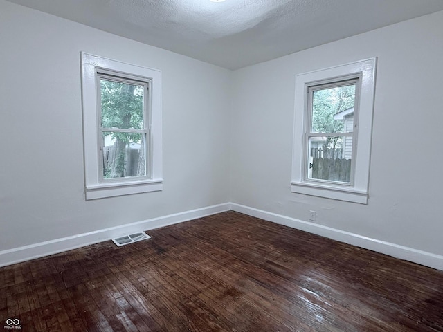 1032 Groff Ave, Indianapolis, IN 46222 - empty room featuring healthy amount of natural light, dark wood-type flooring, and baseboards