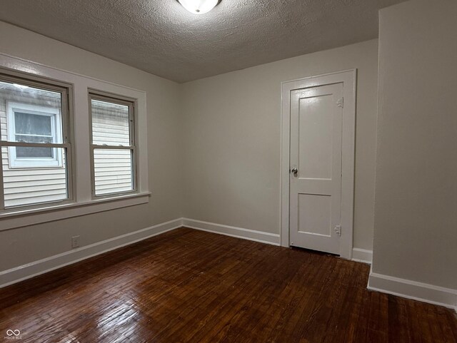 1032 Groff Ave, Indianapolis, IN 46222 - unfurnished room with dark wood-style floors, baseboards, and a textured ceiling