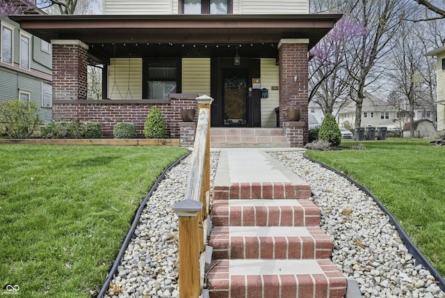 40 N Ritter Ave, Indianapolis, IN 46219 - entrance to property with covered porch, a lawn, and brick siding