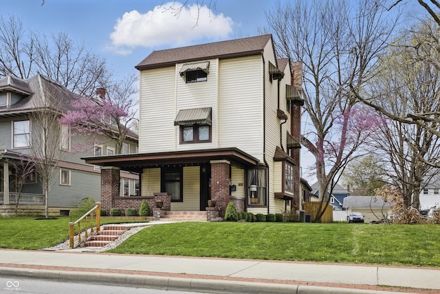 40 N Ritter Ave, Indianapolis, IN 46219 - view of front of property featuring covered porch, a front yard, and brick siding