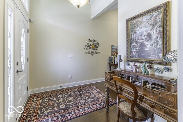 entrance foyer featuring wood finished floors and baseboards