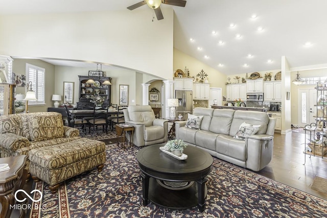 living area with recessed lighting, ornate columns, ceiling fan, high vaulted ceiling, and wood finished floors