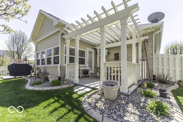rear view of property with a pergola, a patio area, fence, and a lawn