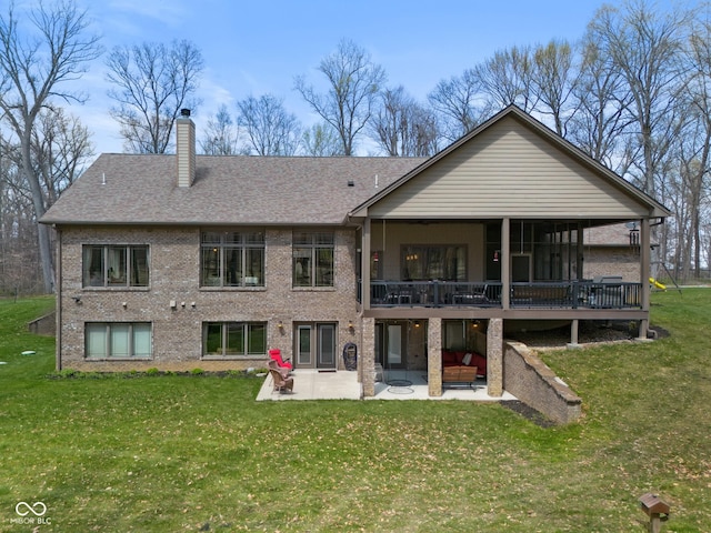 7777 E County Road 50 N, Seymour, IN 47274 - rear view of house with a patio, brick siding, and a yard