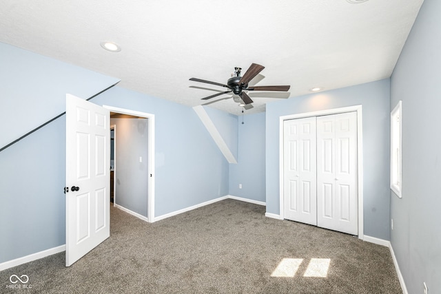 unfurnished bedroom with a closet, recessed lighting, carpet flooring, and baseboards