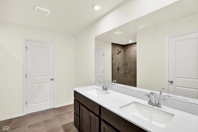 3727 Thomas Jefferson Ct, Westfield, IN 46074 - bathroom featuring a tile shower, double vanity, recessed lighting, and baseboards