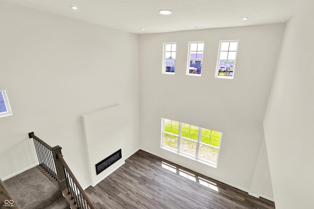 3727 Thomas Jefferson Ct, Westfield, IN 46074 - unfurnished living room with wood finished floors, recessed lighting, a towering ceiling, and baseboards