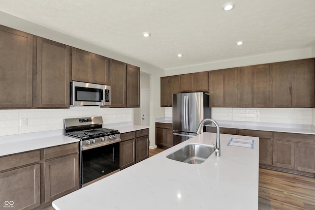 3727 Thomas Jefferson Ct, Westfield, IN 46074 - kitchen with stainless steel appliances, a sink, backsplash, light countertops, and recessed lighting