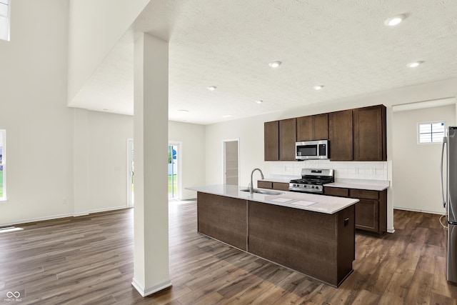 3727 Thomas Jefferson Ct, Westfield, IN 46074 - kitchen with stainless steel appliances, a sink, dark wood-style floors, backsplash, and dark brown cabinetry