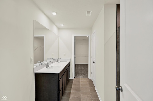 3727 Thomas Jefferson Ct, Westfield, IN 46074 - bathroom featuring double vanity, a spacious closet, tile patterned flooring, baseboards, and recessed lighting
