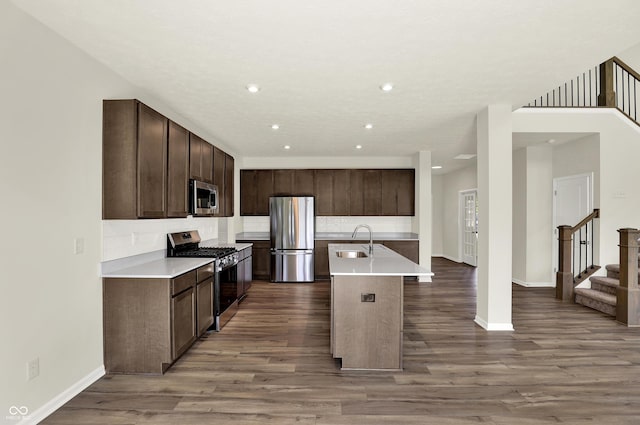 3727 Thomas Jefferson Ct, Westfield, IN 46074 - kitchen featuring appliances with stainless steel finishes, a sink, wood finished floors, backsplash, and recessed lighting