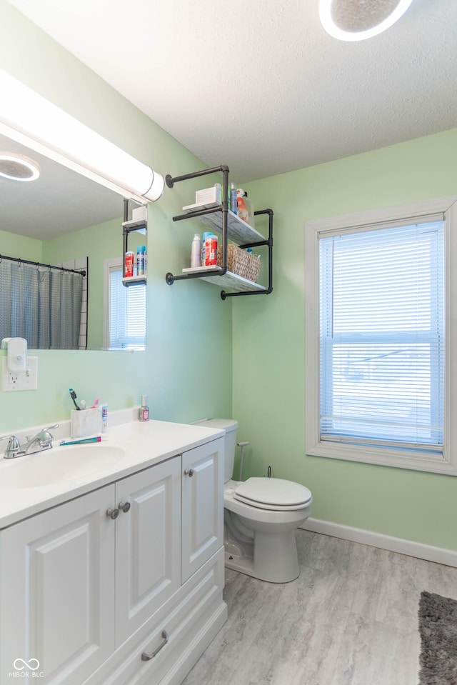504 S Lebanon St, Lebanon, IN 46052 - full bathroom featuring a wealth of natural light, vanity, toilet, and wood finished floors