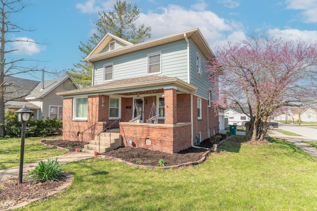 504 S Lebanon St, Lebanon, IN 46052 - view of front facade featuring brick siding, a front yard, and a porch