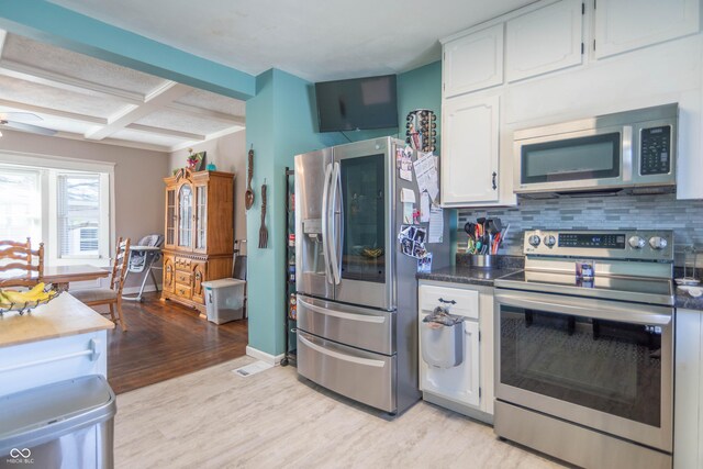 504 S Lebanon St, Lebanon, IN 46052 - kitchen featuring stainless steel appliances, tasteful backsplash, light wood-style floors, and white cabinets