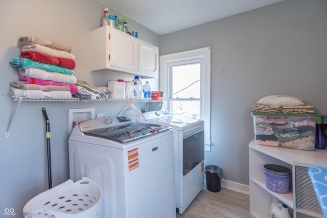 504 S Lebanon St, Lebanon, IN 46052 - laundry room featuring cabinet space, washer and clothes dryer, light wood-type flooring, and baseboards