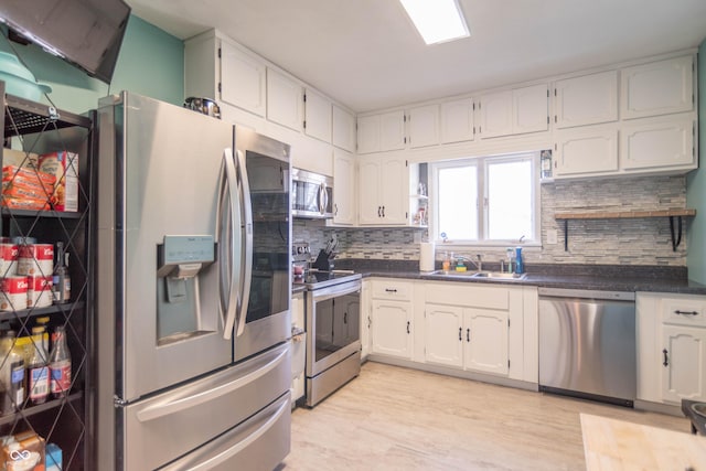 504 S Lebanon St, Lebanon, IN 46052 - kitchen with tasteful backsplash, appliances with stainless steel finishes, a sink, and dark countertops