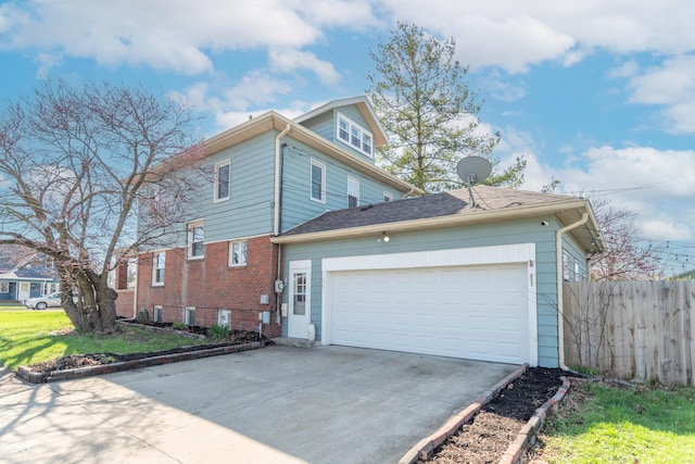 504 S Lebanon St, Lebanon, IN 46052 - view of home's exterior with driveway, an attached garage, brick siding, fence, and a lawn