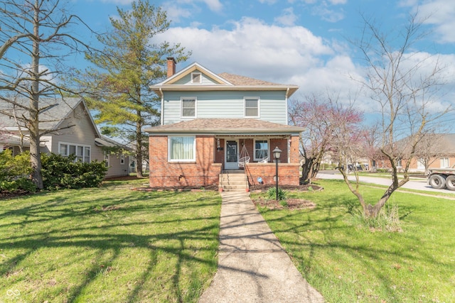 504 S Lebanon St, Lebanon, IN 46052 - view of front facade with brick siding, a chimney, a front lawn, and covered porch