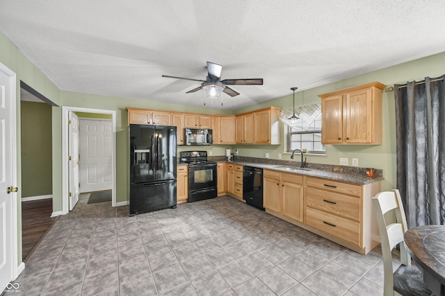 kitchen with a ceiling fan, black appliances, pendant lighting, a sink, and light brown cabinetry