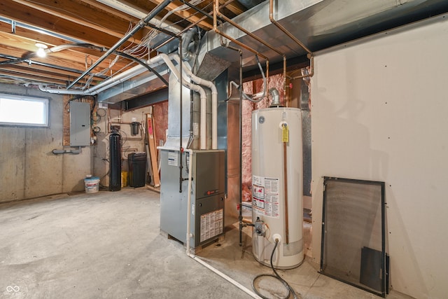 below grade area with electric panel, heating unit, and gas water heater