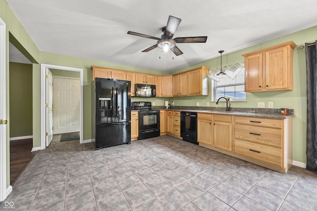 kitchen featuring a sink, light brown cabinets, a ceiling fan, and black appliances