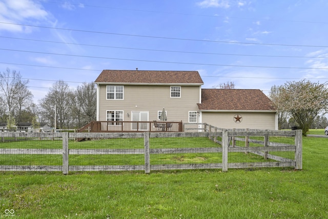 back of property featuring roof with shingles, a yard, a wooden deck, and fence
