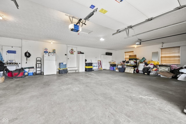 garage with freestanding refrigerator and a garage door opener