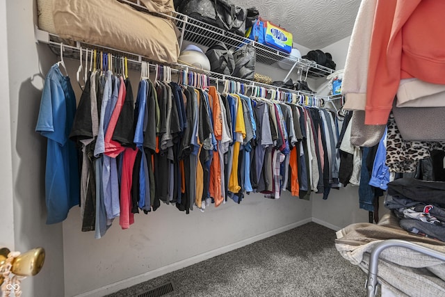 walk in closet featuring visible vents and carpet flooring