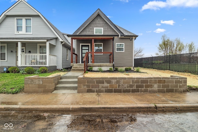 view of front of property with fence and covered porch