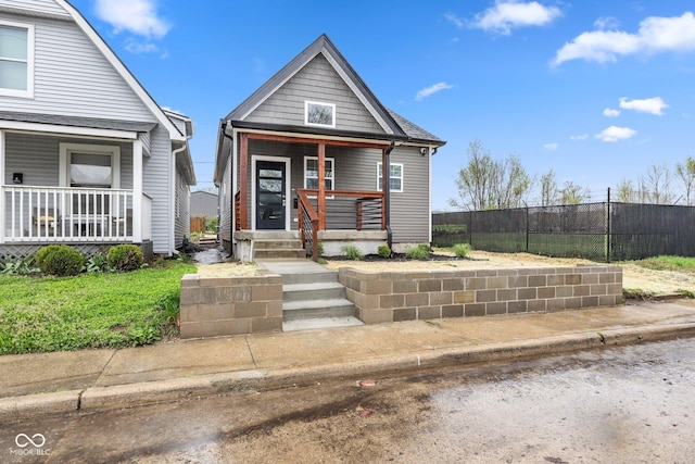 view of front facade with a porch and fence