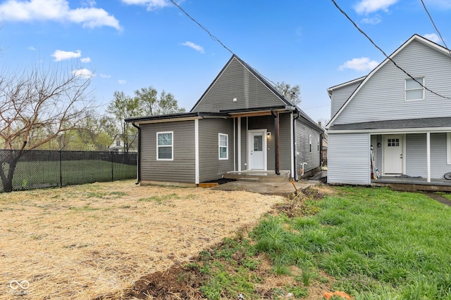 rear view of house featuring fence