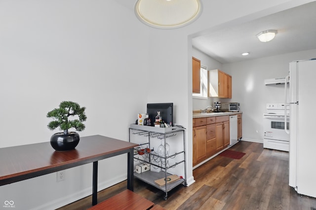 443 N Alton Ave, Indianapolis, IN 46222 - kitchen with white appliances, under cabinet range hood, dark wood-style floors, light countertops, and a sink