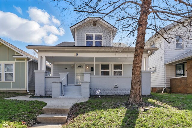 443 N Alton Ave, Indianapolis, IN 46222 - view of front facade featuring covered porch and a front yard