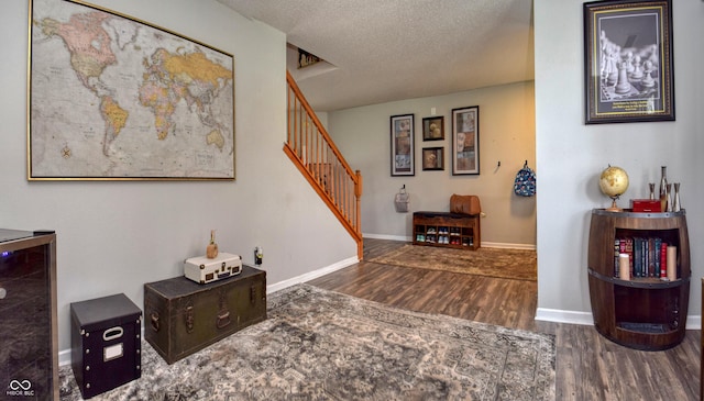 9873 Blue Ridge Way, Indianapolis, IN 46234 - hall with wood finished floors, stairway, a textured ceiling, and baseboards