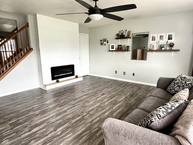 9873 Blue Ridge Way, Indianapolis, IN 46234 - living room with wood finished floors, ceiling fan, a textured ceiling, stairs, and a large fireplace