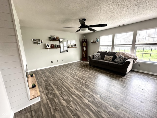 9873 Blue Ridge Way, Indianapolis, IN 46234 - living room featuring a textured ceiling, ceiling fan, dark wood-type flooring, and baseboards