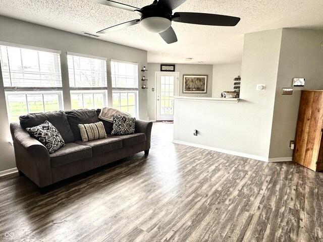 9873 Blue Ridge Way, Indianapolis, IN 46234 - living room with wood finished floors, a ceiling fan, a textured ceiling, and baseboards