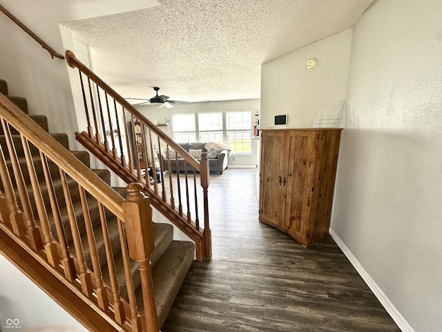 9873 Blue Ridge Way, Indianapolis, IN 46234 - stairs featuring a textured ceiling, wood finished floors, ceiling fan, and baseboards