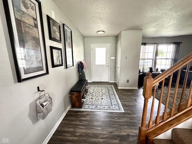 9873 Blue Ridge Way, Indianapolis, IN 46234 - entryway with a textured ceiling, baseboards, wood finished floors, and stairway