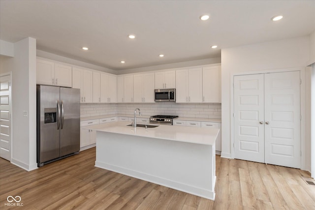 13423 E 134th St, Fishers, IN 46037 - kitchen featuring appliances with stainless steel finishes, light countertops, white cabinets, a center island with sink, and recessed lighting