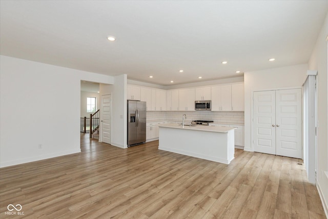 13423 E 134th St, Fishers, IN 46037 - kitchen featuring stainless steel appliances, light countertops, light wood finished floors, white cabinets, and recessed lighting