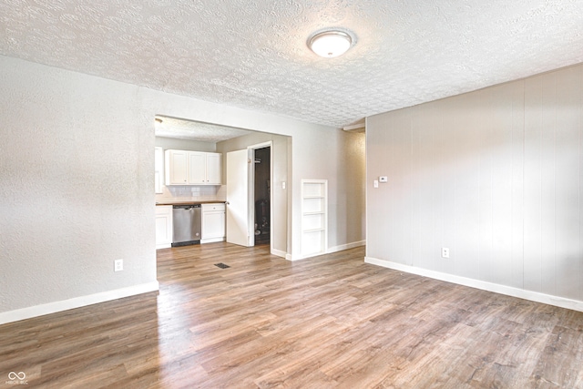 6189 Vigo Dr, Clayton, IN 46118 - unfurnished living room with a textured ceiling, light wood finished floors, and a textured wall