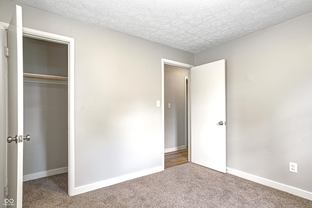 6189 Vigo Dr, Clayton, IN 46118 - unfurnished bedroom with carpet flooring, a closet, and a textured ceiling
