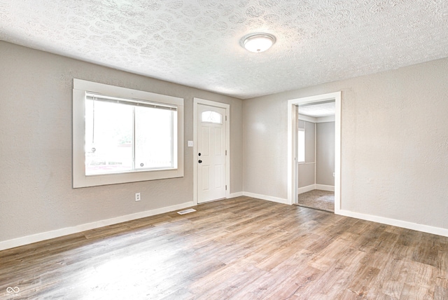 6189 Vigo Dr, Clayton, IN 46118 - foyer entrance with wood finished floors, a textured ceiling, and a textured wall