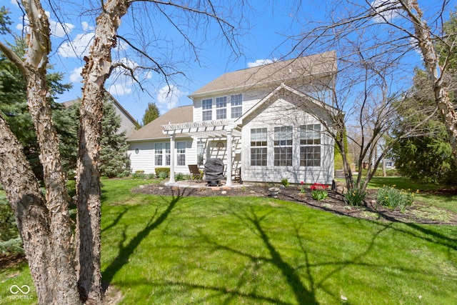 back of house with a lawn, roof with shingles, a pergola, and a patio area
